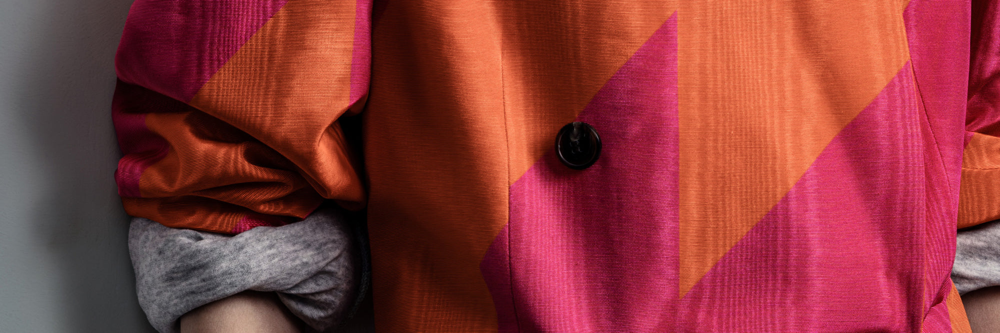 Close-up of a colorful fabric with a geometric pattern on a gray background- Dries Van Noten