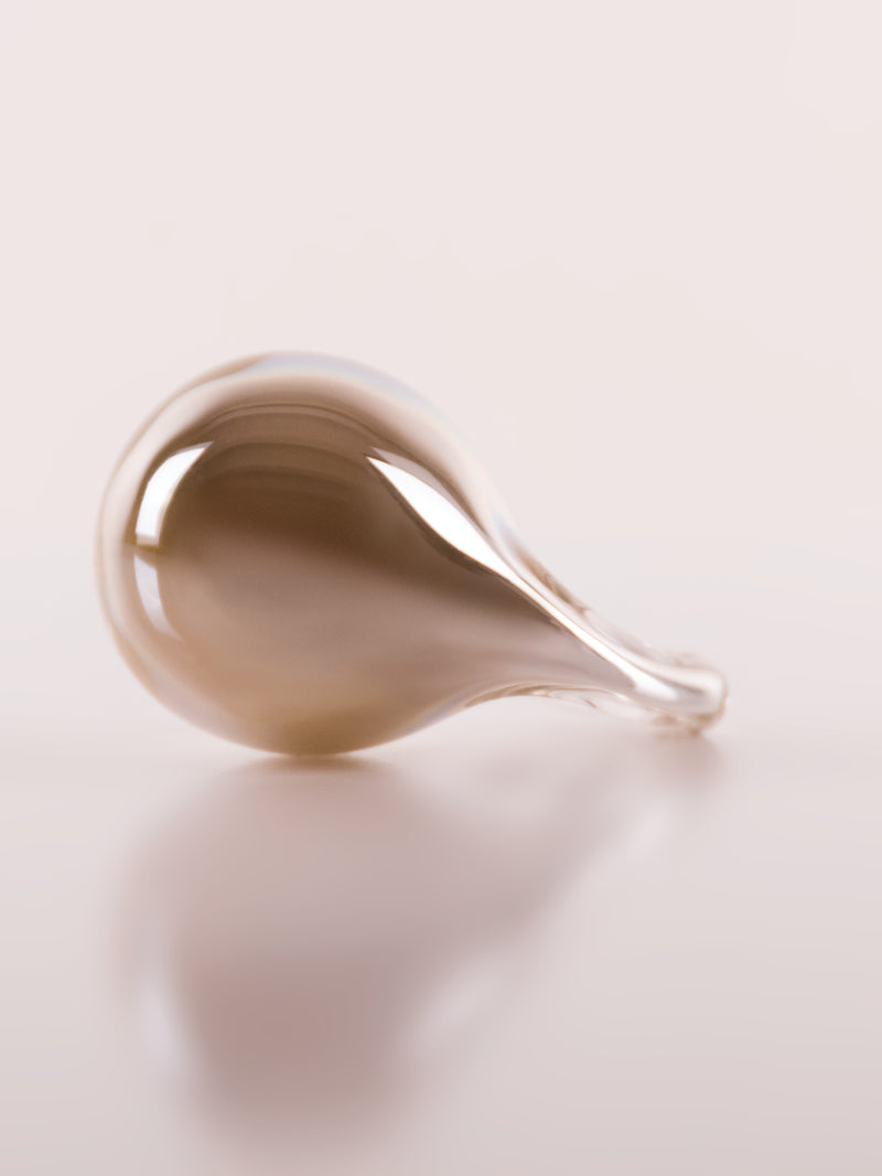 Close-up of a teardrop-shaped object on a white background