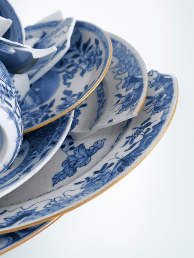 Blue and white ceramic tableware set on a white background - Dries Van Noten