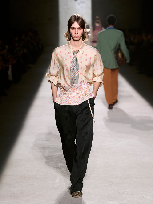 Model walking on a runway wearing a floral shirt and black pants - Dries Van Noten