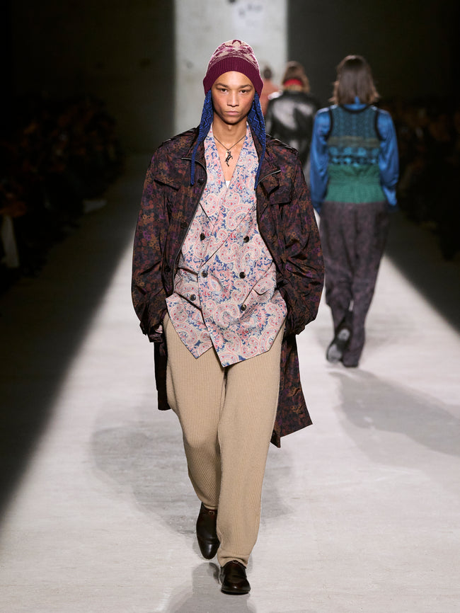 Model walking on a runway wearing a patterned coat and floral blouse - Dries Van Noten