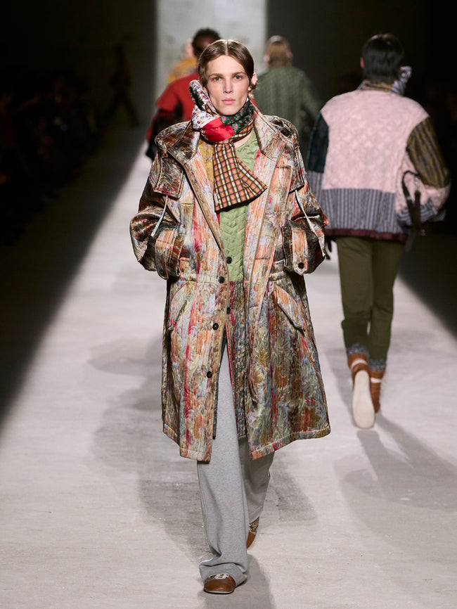 Model walking on a runway wearing a patterned coat during a fashion show - Dries Van Noten