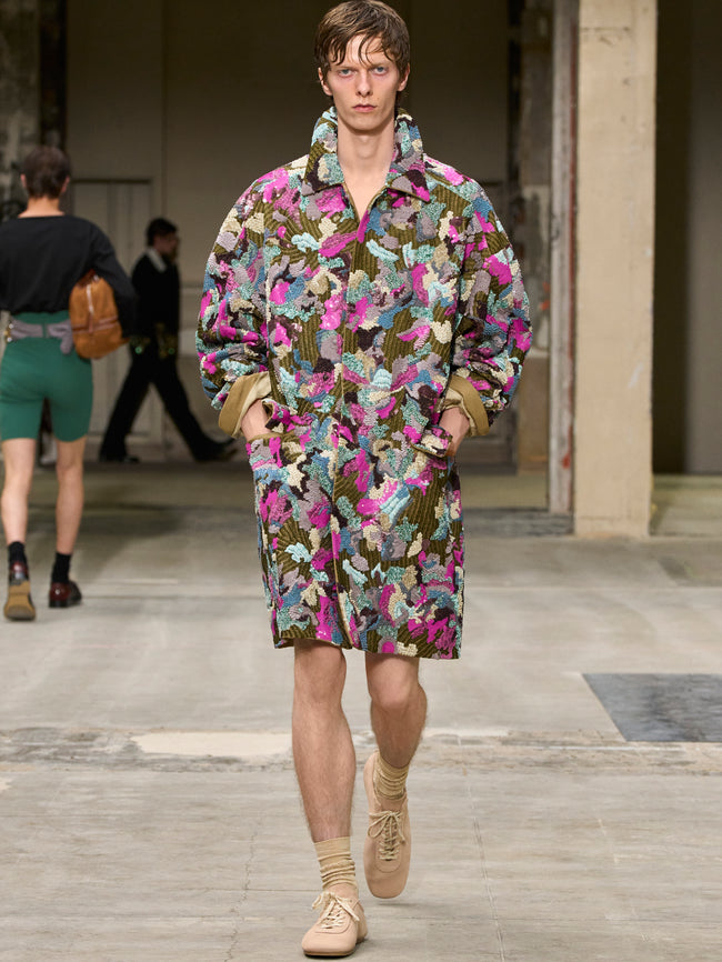 Model wearing a colorful floral outfit on a runway - Dries Van Noten