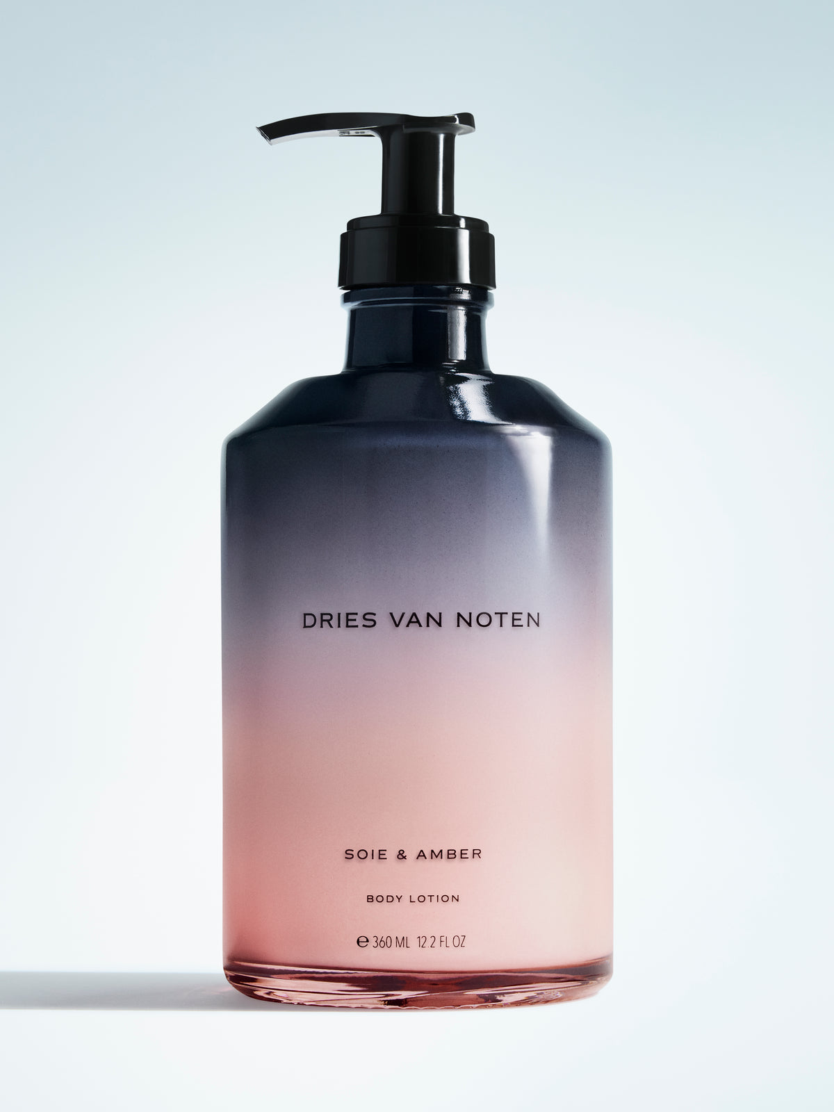 Gradient bottle of Dries Van Noten body lotion on a light background