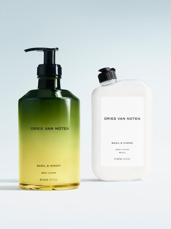 Dries Van Noten body lotion in a gradient glass pump bottle displayed next to its matching refill container 
