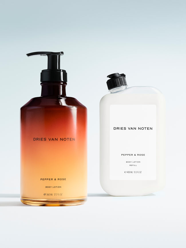 Dries Van Noten body lotion in a gradient glass pump bottle displayed next to its matching refill container 