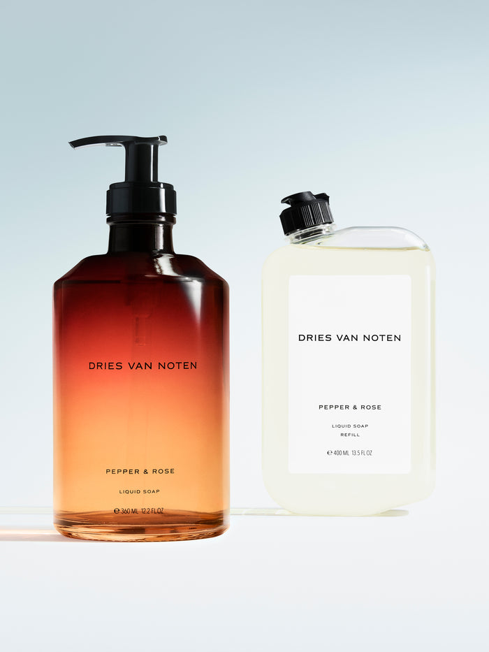 Dries Van Noten liquid soap in a gradient glass pump bottle displayed next to its matching refill container 