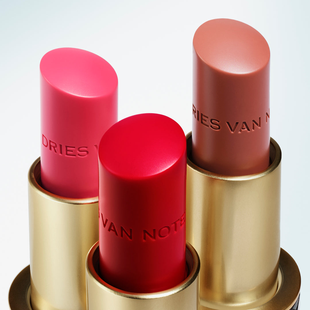 Set of three lip balm bullets on a white background
