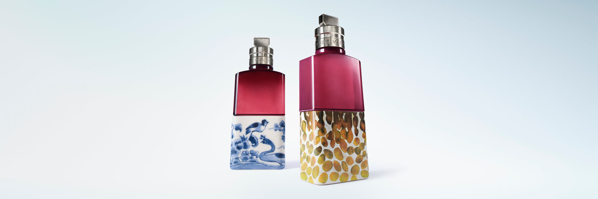 Two fragrance bottles, one featuring a blue and white wave pattern base and the other a textured gold base, set against a light blue gradient background.