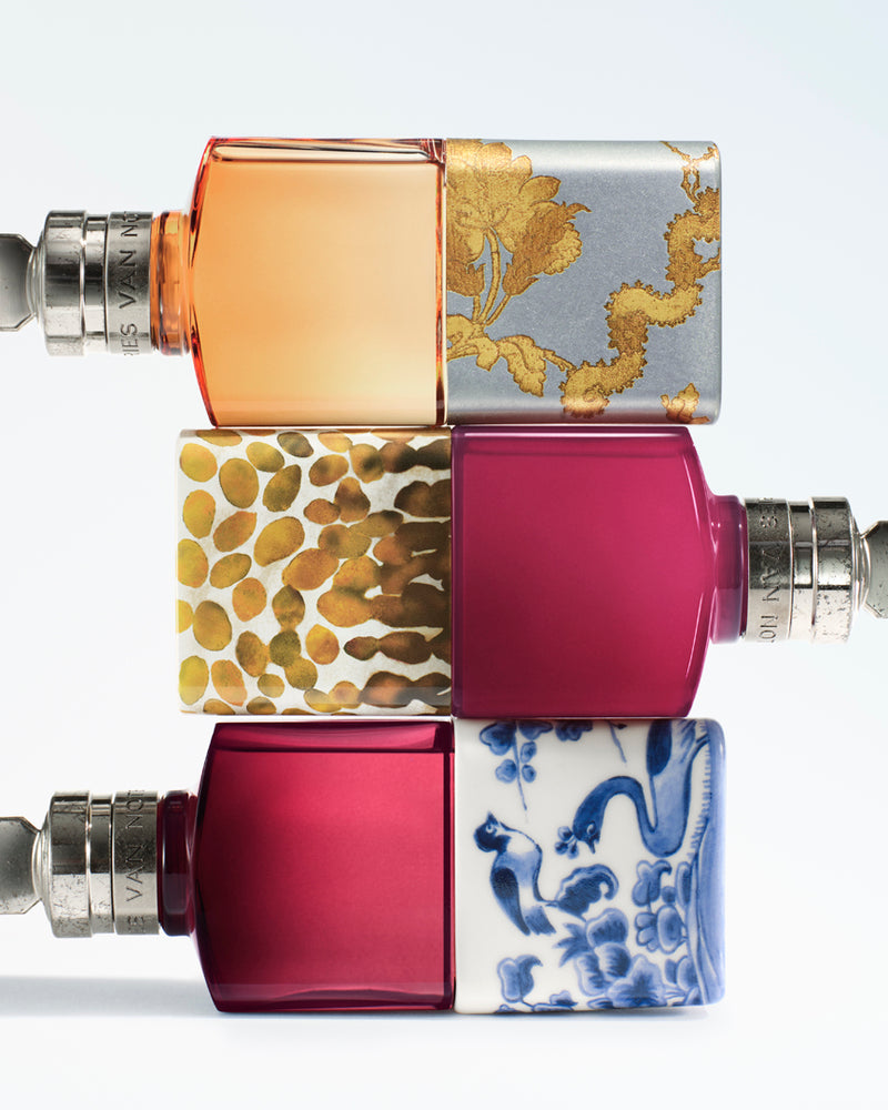 Three rectangular fragrance bottles stacked vertically on a light blue gradient background.