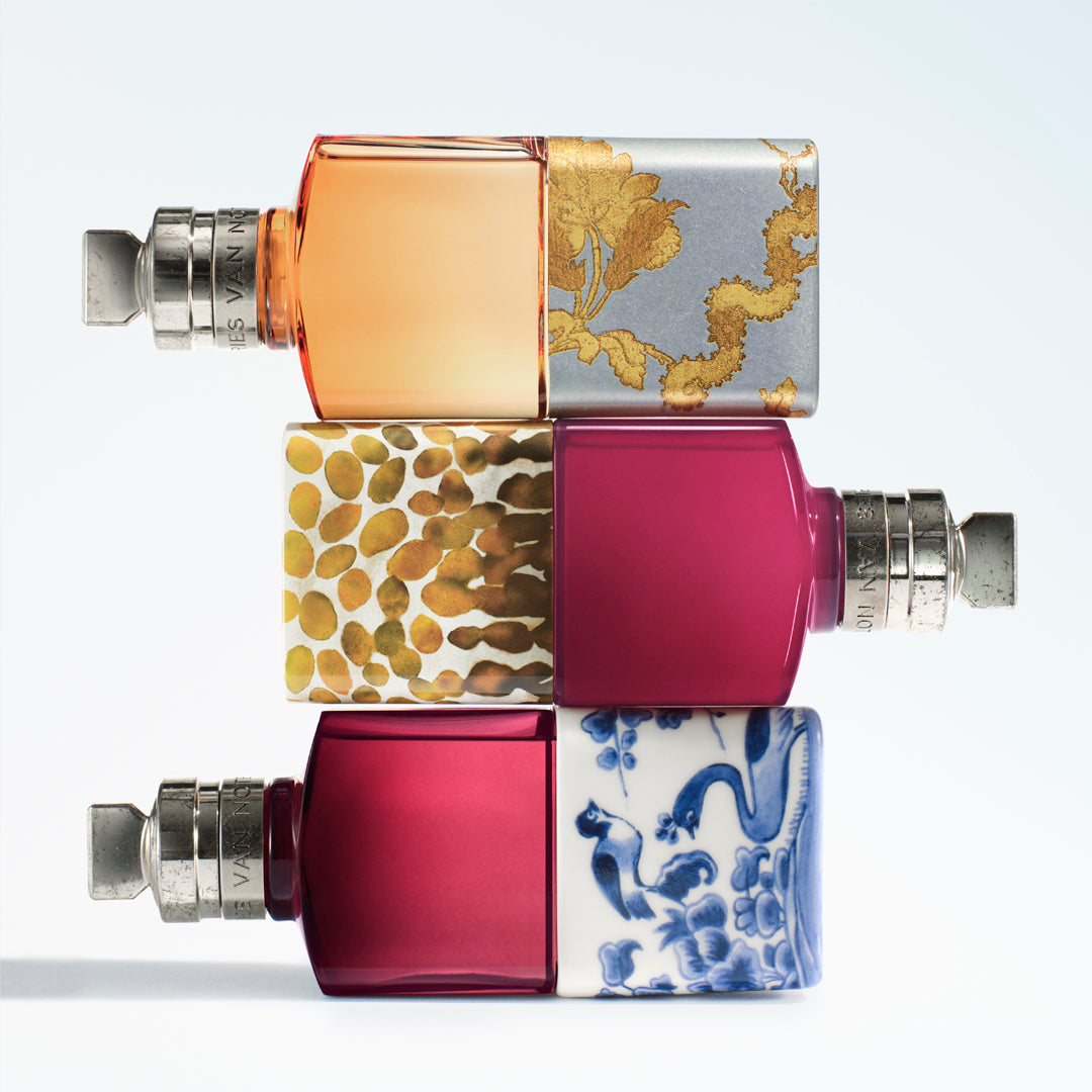 Three rectangular fragrance bottles stacked vertically on a light blue gradient background.