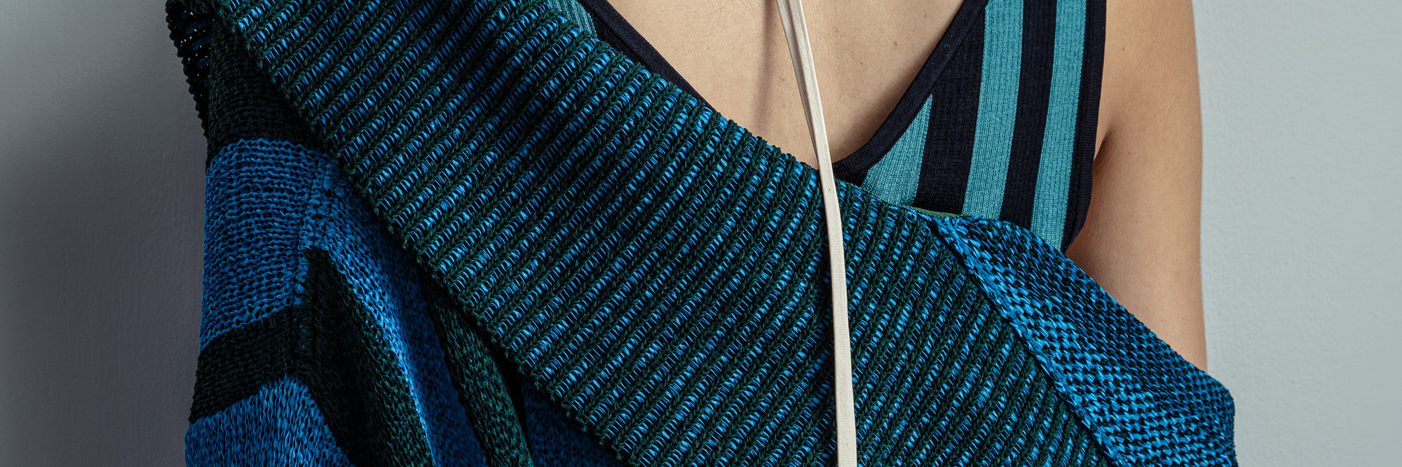 Close-up of a blue textured garment with a gray background - Dries Van Noten