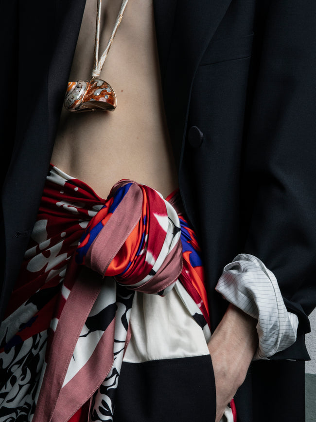 Person wearing a colorful scarf with a plain background