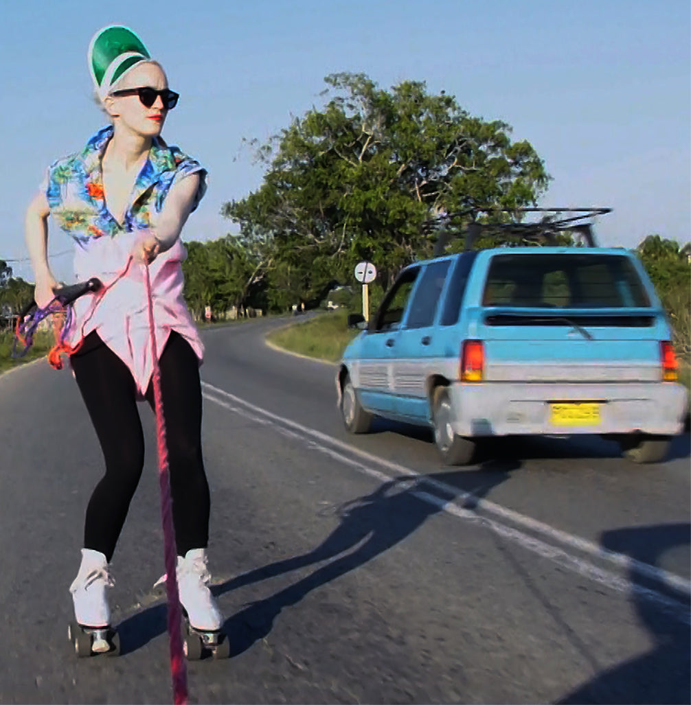 artist on roller skates and a car