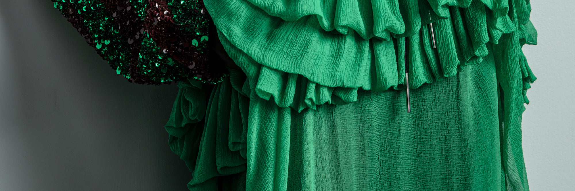 Green ruffled dress with sequined top on a gray background- Dries Van Noten
