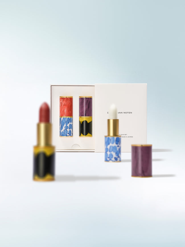 Lipsticks and a box on a light blue background