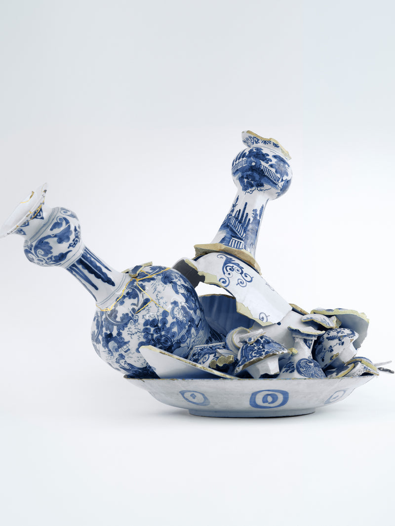 Blue and white ceramic decanter with intricate designs on a light gray background - Dries Van Noten