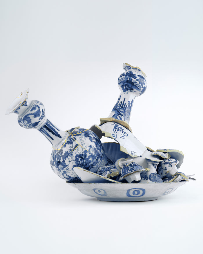 Blue and white ceramic decanter with intricate designs on a light gray background - Dries Van Noten