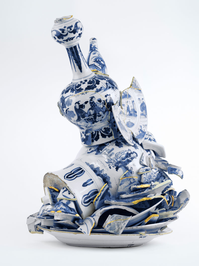 Blue and white ceramic decanter with intricate designs on a light gray background - Dries Van Noten