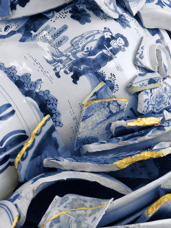 Blue and white ceramic pieces with intricate designs on a white background - Dries Van Noten