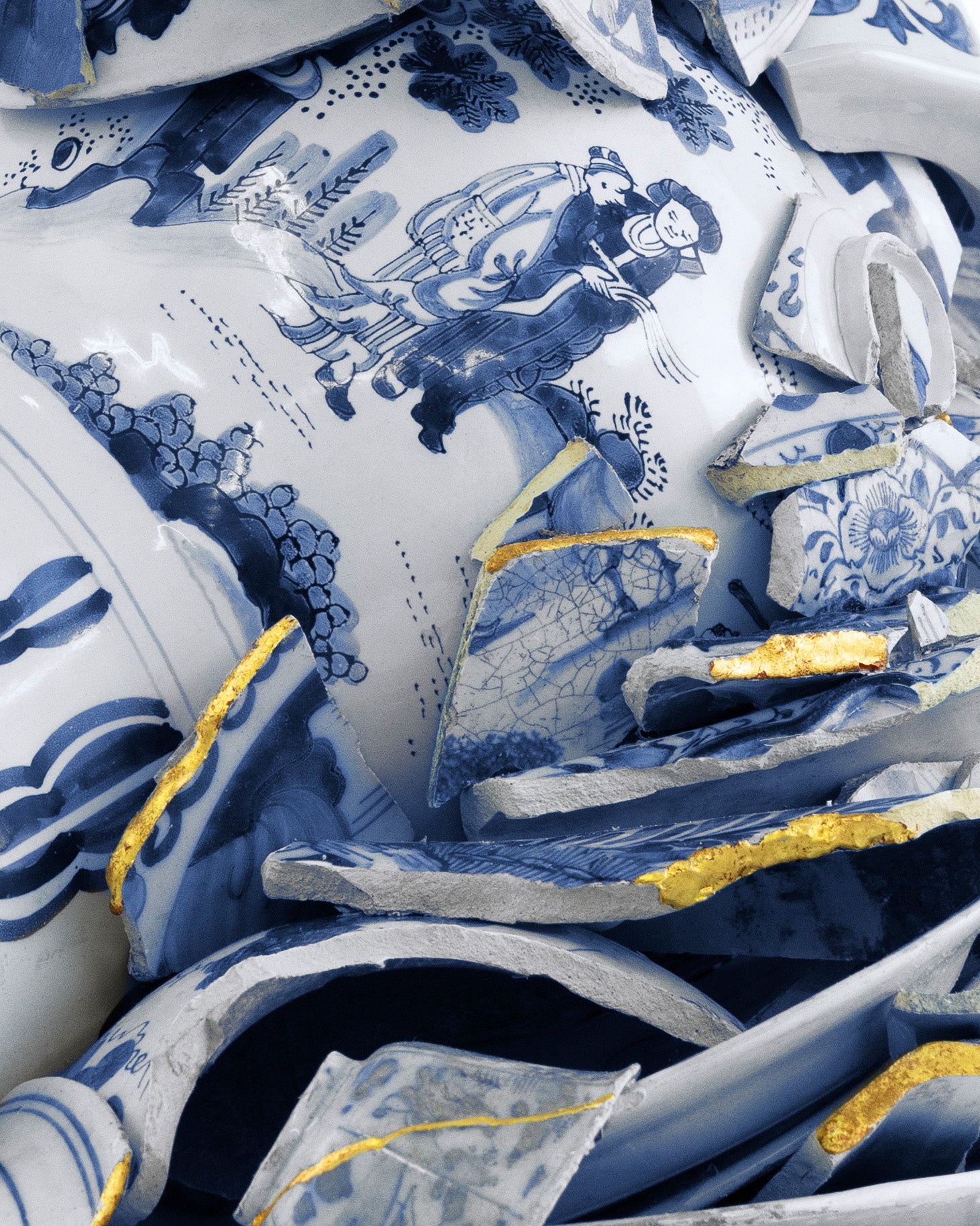 Blue and white ceramic pieces with intricate designs on a white background - Dries Van Noten