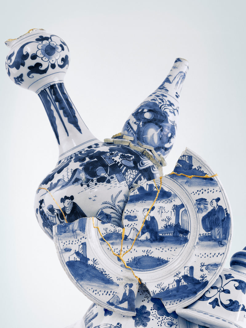 Blue and white ceramic decanter with intricate designs on a light gray background - Dries Van Noten