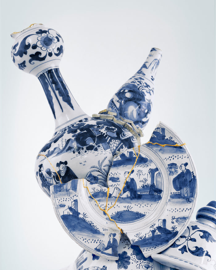 Blue and white ceramic decanter with intricate designs on a light gray background - Dries Van Noten