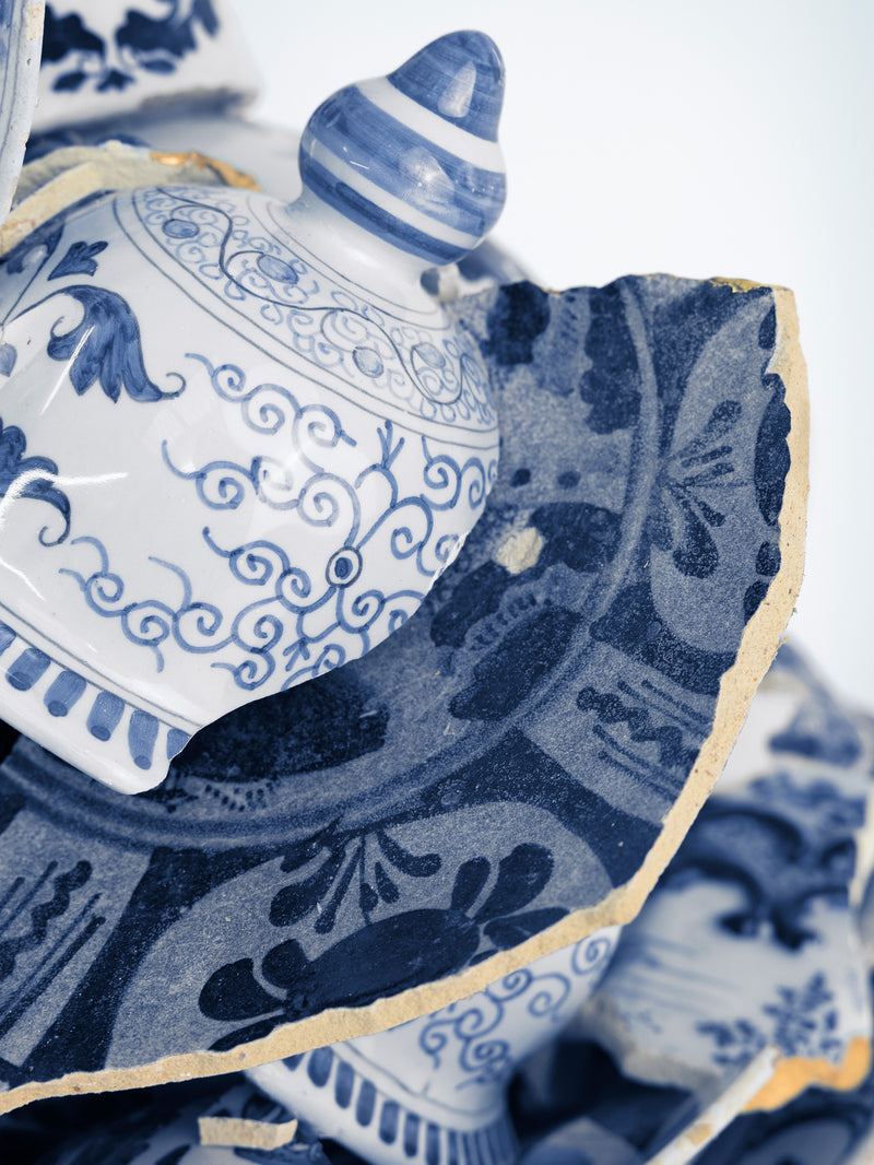 Blue and white ceramic pieces with intricate patterns on a white  background - Dries Van Noten