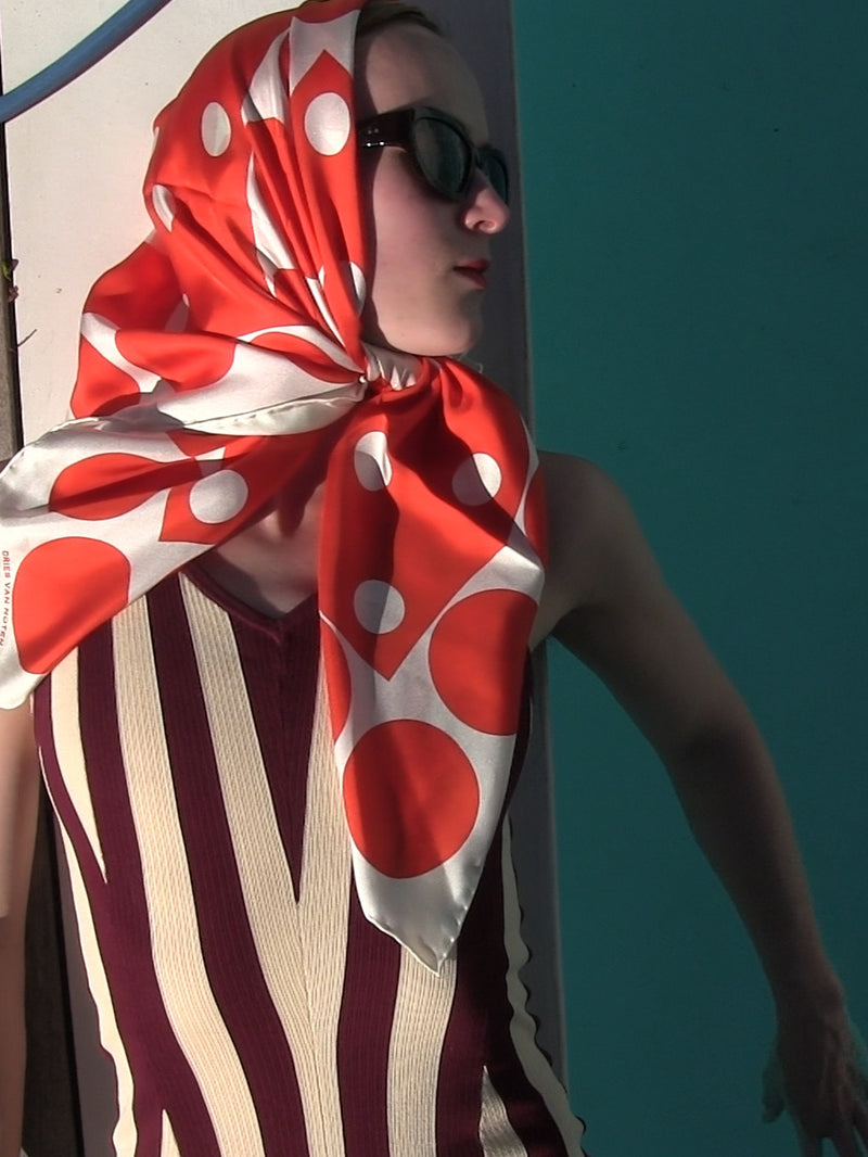 Woman wearing a red and white polka dot headscarf