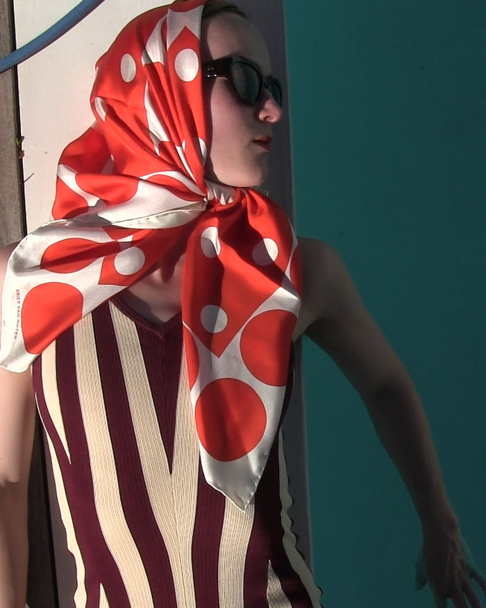 Woman wearing a red and white polka dot headscarf