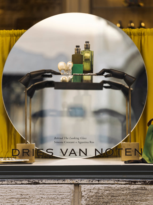 Dries Van Noten display with perfume bottles and a mirror
