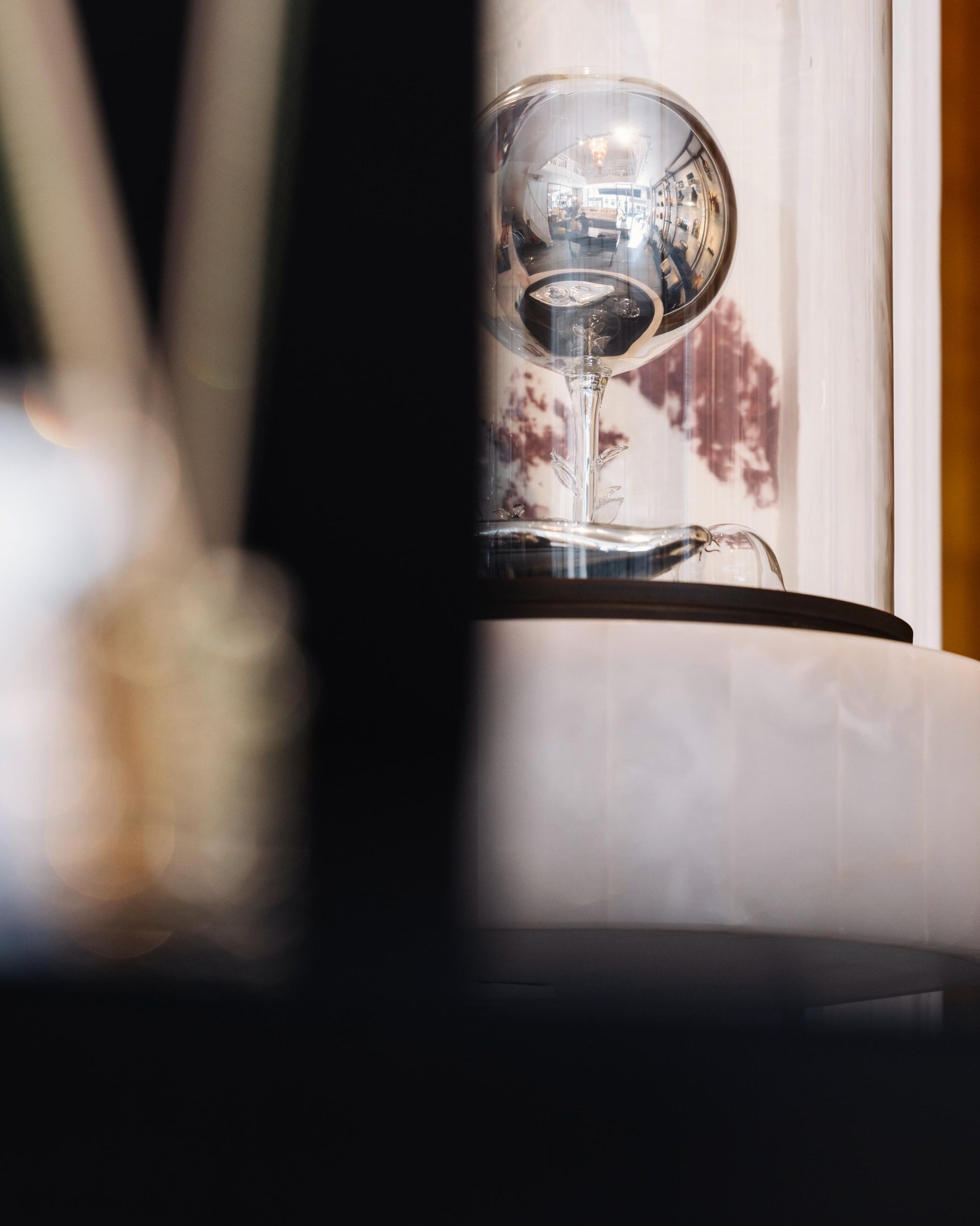 Close-up of a modern lamp with a glass shade on a blurred background