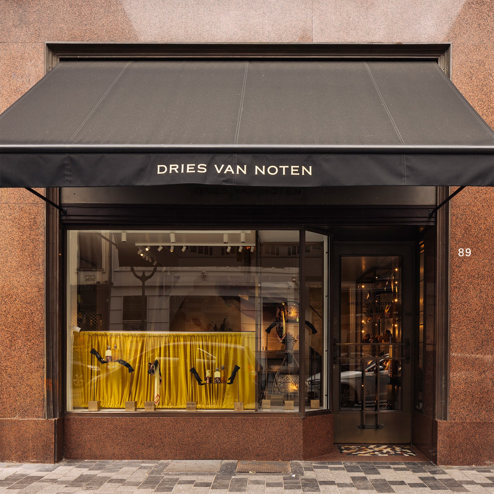 Outside of store with a window decorated with perfume bottles and accessories