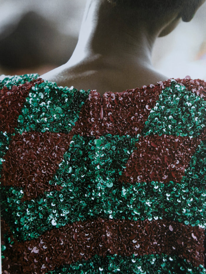 Close-up of a sequined garment with green and brown pattern