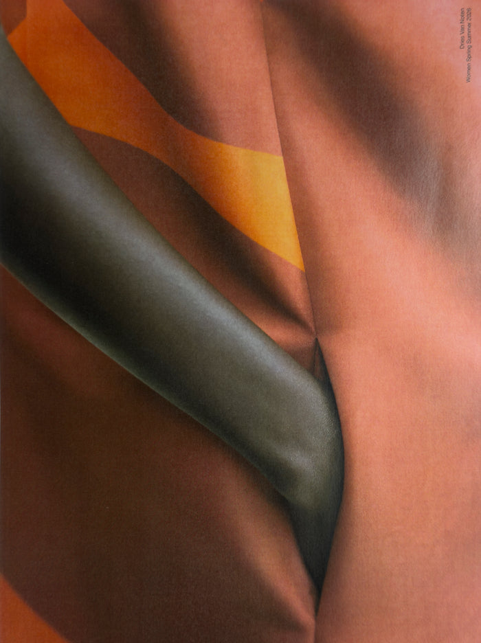 Close-up of fabric with brown, green, and orange colors
