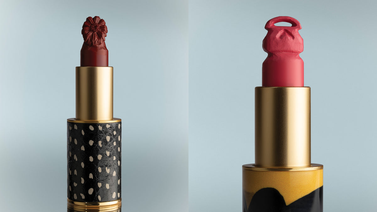 Two lipsticks with unique caps on a light gray background