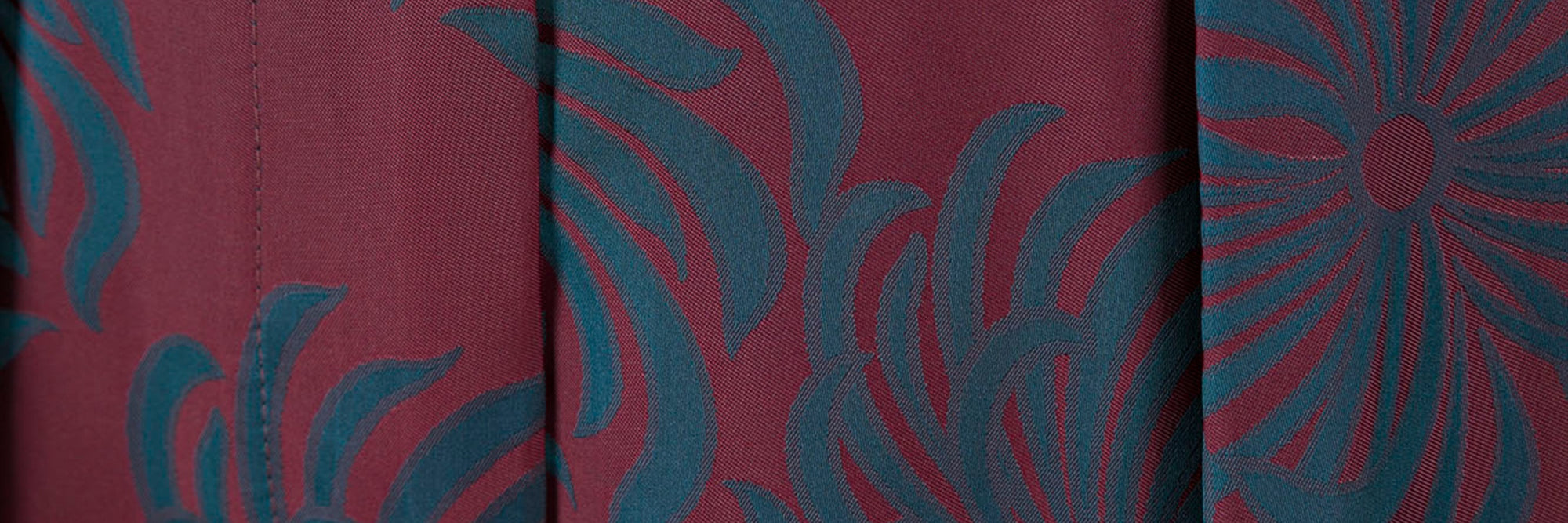 Textile with blue floral pattern on red background